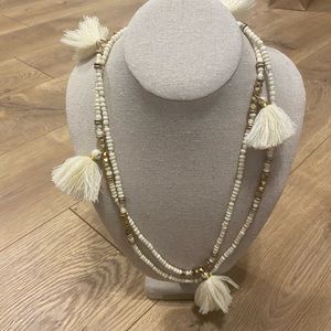 Long beaded necklace with white tassels